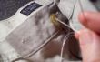 Hoe om te naaien een knop op een paar broek